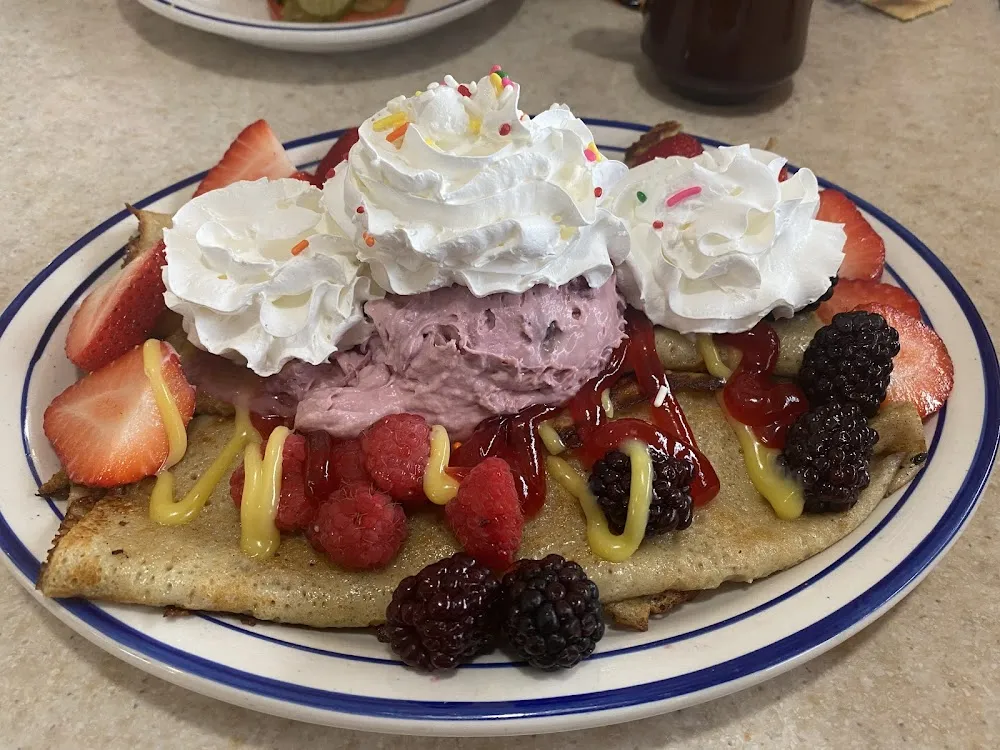 Berry Bliss Crepes & Grits with Hash Browns Sausage Gravy & Cheese
